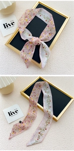 Detail of floral chiffon skinny scarf showing light pink fabric and delicate stitching