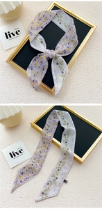 Detail of floral skinny scarf showing purple flowers and smooth chiffon texture