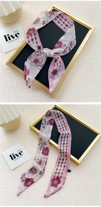 Macro detail of retro floral silk scarf with geometric patterns and authentic wash label
