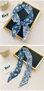 Detail of silk-feel scarf featuring dual-sided floral prints and French elegant design