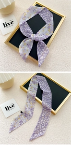 Close-up of narrow purple floral silk scarf with double-sided pattern and slanted ends