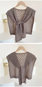 Detail of dark brown hollow-out knit shawl with intricate diamond mesh crochet texture