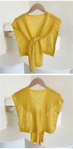 Front and back views of a bright yellow hollow knit shawl with tied knot detail