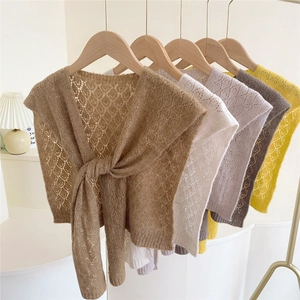 Women's hollow knit shawl wrap featuring diamond crochet pattern and tie-knot design