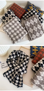 Close-up of thick knitted scarves featuring houndstooth and geometric patterns