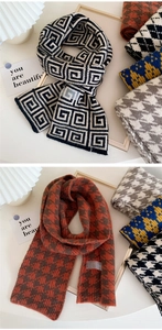 Detail of soft knitted scarf featuring geometric Greek key and houndstooth patterns