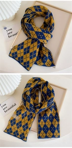 Detail of yellow and blue argyle knit scarf with thick wool texture and tassels