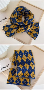 Detail of blue and yellow diamond knit scarf with soft texture and retro pattern