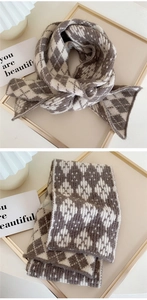 Detail of knitted scarf showing coffee and beige diamond patterns and soft texture