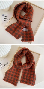 Macro detail of houndstooth knit scarf with orange and brown vintage pattern textures