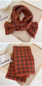Detail of orange and brown houndstooth knit scarf with close-up of soft texture