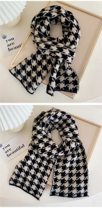 Close-up of black and white houndstooth knit scarf with soft cashmere-like texture
