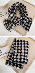 Detail of soft knit material and thick texture on black and white houndstooth scarf