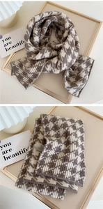 Detail of soft brown and beige houndstooth knit scarf texture with thick warm material