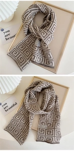 Macro detail of thick geometric labyrinth pattern and premium woven tag on knit scarf