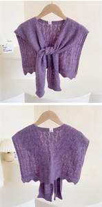 Close-up of purple knit shawl with hollow crochet texture and wavy scalloped edges