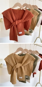 Detailed knit cable pattern and decorative lace-up collar on various colored shawls