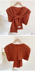 Detail of caramel knit hollow shawl with knotted design and cable pattern texture