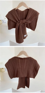 Detail of dark brown knitted shawl with waffle texture and elegant crochet stripe patterns