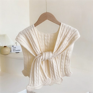 Knitted cable-knit shawl wrap in cream white with a stylish front knot and wavy edges