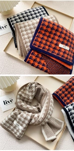 Detailed knit texture of houndstooth scarf with elegant stitched brand label and soft fabric