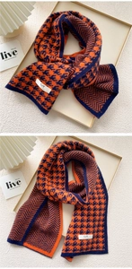 Detail of soft knit scarf featuring orange and navy houndstooth pattern and brand label