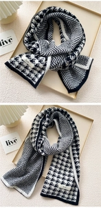 Detail of knitted black and white houndstooth scarf with classic chevron pattern texture
