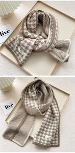 Close-up of thick knitted scarf with houndstooth and herringbone double-sided patterns