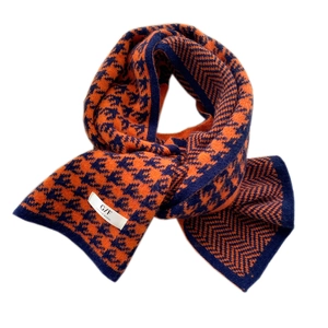 Long knitted houndstooth scarf with orange and navy blue geometric patterns