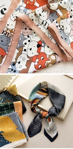 Detail of printed silk scarf showing cute cat patterns and smooth fabric texture