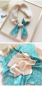 Detail of lake green and champagne geometric plaid silk scarf with satin finish and elegant border