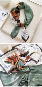 Close-up of silk square scarf featuring detailed artistic pegasus and floral prints