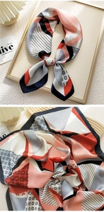 Close-up of geometric pattern silk scarf with satin finish and elegant folding detail