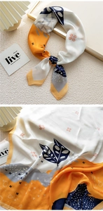 Detailed pattern of a silk scarf with contrast prints, abstract leaves and polka dots