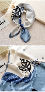 Detailed view of the blue and white leaf print on a premium silk satin square scarf