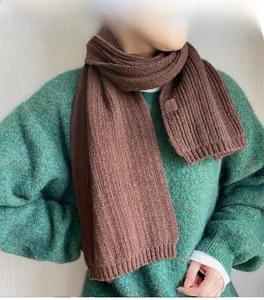 Detailed texture of coffee brown ribbed knit scarf with a minimalist woven label design