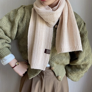 Beige knitted ribbed scarf for women styled with vintage green cardigan for autumn winter