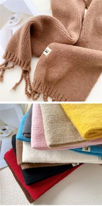 Detail of soft chunky knit scarf with fringed tassels and various color options
