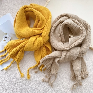 Thick knitted fringe scarves in vibrant yellow and soft beige for autumn and winter warmth