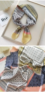 Detailed print of silk square scarf with geometric floral patterns and soft color blocks