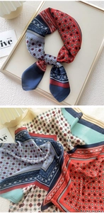 Detail of silk-like square scarf with retro geometric patterns and elegant red border