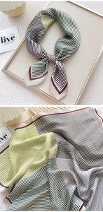 Close-up of geometric striped silk scarf with satin texture in green and brown tones