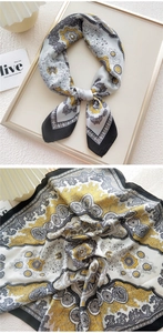 Detail of 70x70 paisley pattern silk scarf with yellow and grey vintage texture