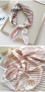 Detail of pink and white striped silk scarf showing texture and elegant folding style