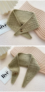 Close-up of grass green cable knit neck warmer with amber button detail and texture