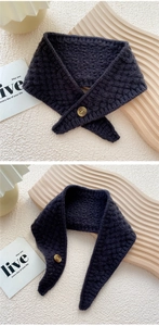 Close-up of waffle-knit scarf featuring dark grey fabric and vintage wooden button detail