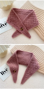 Close-up of pink knit scarf with chunky texture and amber-patterned button detail