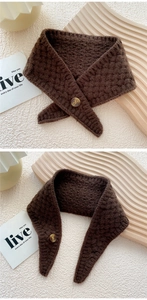 Detail of dark coffee knitted waffle scarf featuring a textured amber button closure