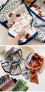 Detail of printed silk-like twilly scarves with floral and houndstooth patterns on a tray