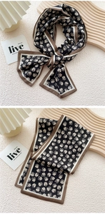 Detail of floral skinny scarf with daisy print and brown contrast border